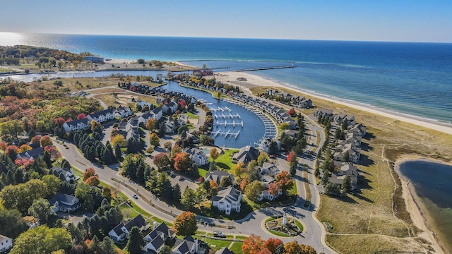 birds eye view of property with a water view and a beach view