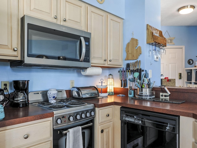 kitchen featuring appliances with stainless steel finishes and cream cabinets