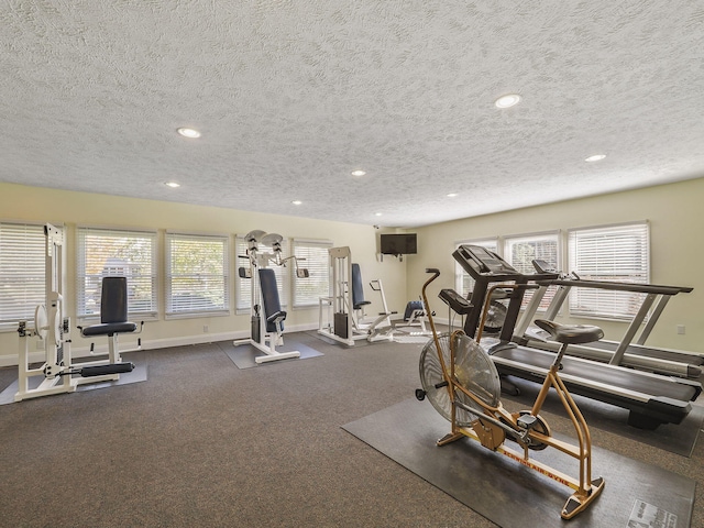 exercise room with a textured ceiling