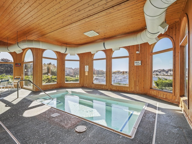 view of swimming pool with a patio and an indoor in ground hot tub