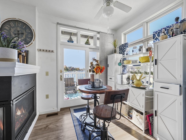 dining room with hardwood / wood-style flooring and ceiling fan