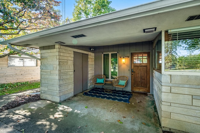 property entrance featuring board and batten siding