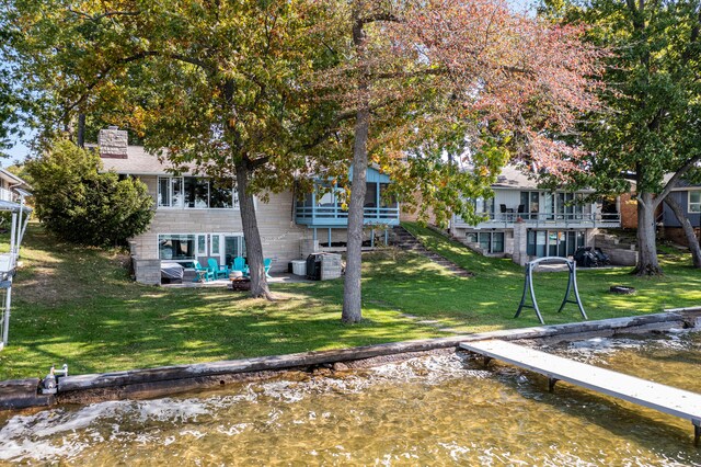 exterior space with a patio area and a water view