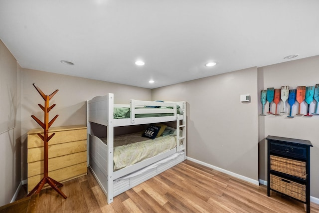 bedroom with recessed lighting, baseboards, and wood finished floors