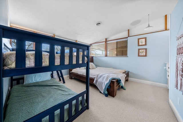 carpeted bedroom featuring visible vents, baseboards, and vaulted ceiling