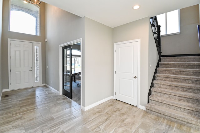 entryway featuring a high ceiling and a healthy amount of sunlight