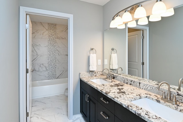 bathroom featuring vanity and tiled shower / bath