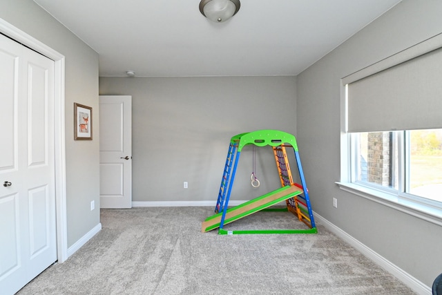 playroom featuring light colored carpet