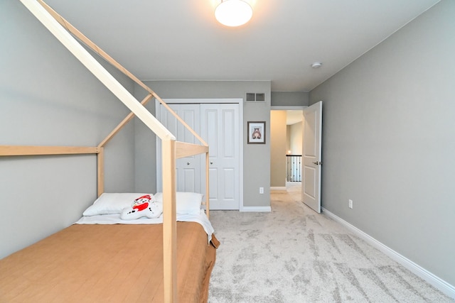 unfurnished bedroom featuring light colored carpet and a closet