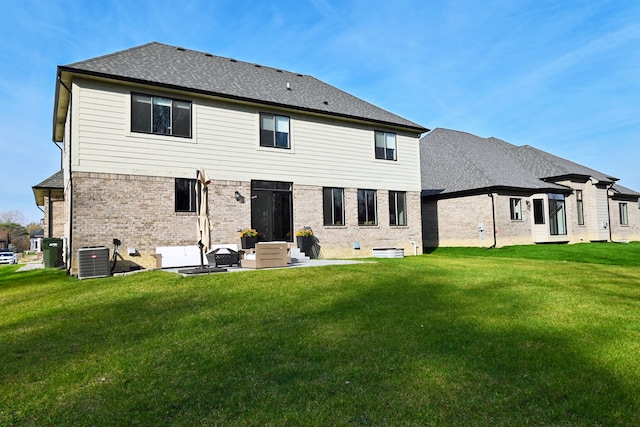 rear view of property featuring a yard and central AC unit