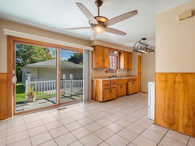 kitchen with ceiling fan, sink, and light tile patterned flooring