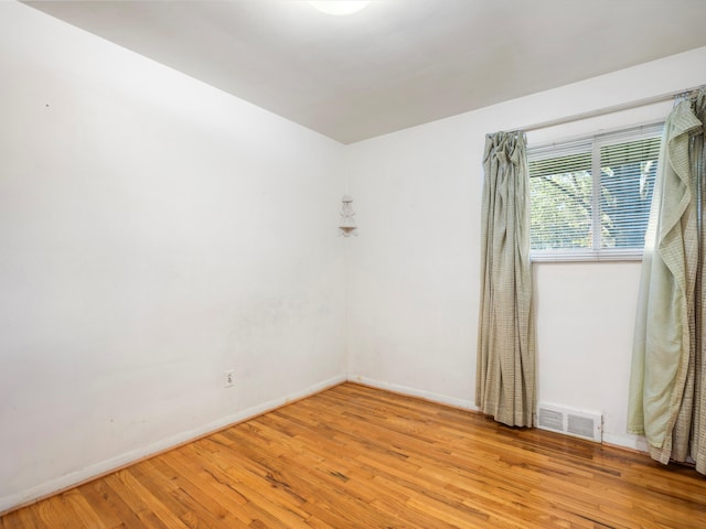 unfurnished room with light hardwood / wood-style flooring