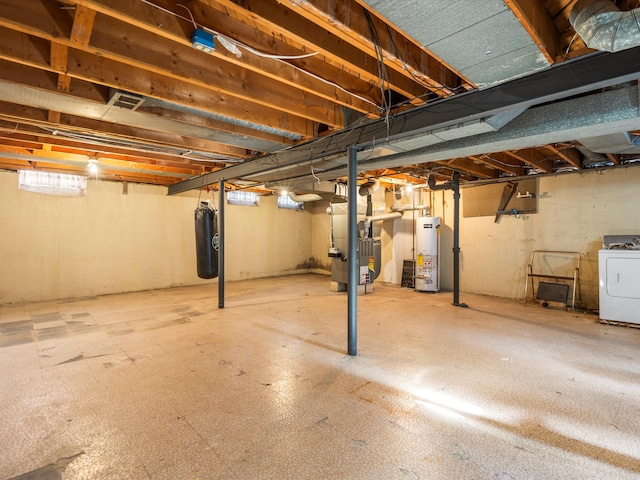 basement featuring washer / dryer, gas water heater, and heating unit