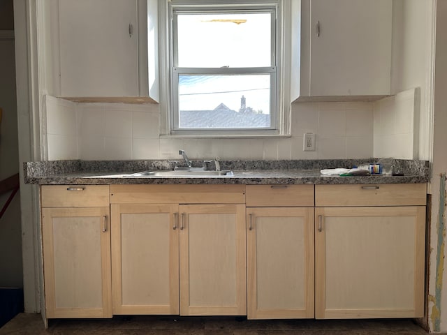 kitchen with decorative backsplash, light brown cabinetry, and sink