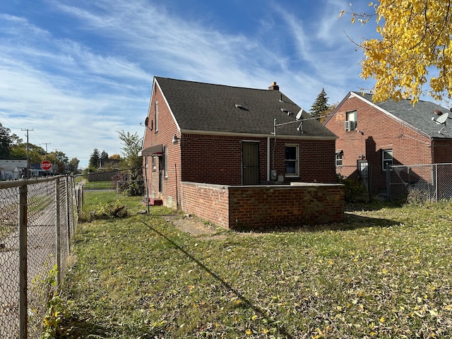 rear view of property with a yard