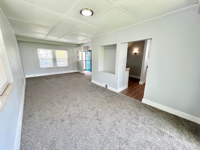 unfurnished room featuring dark colored carpet