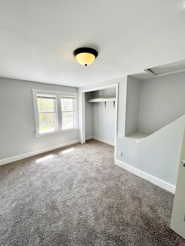 unfurnished bedroom featuring carpet and a closet