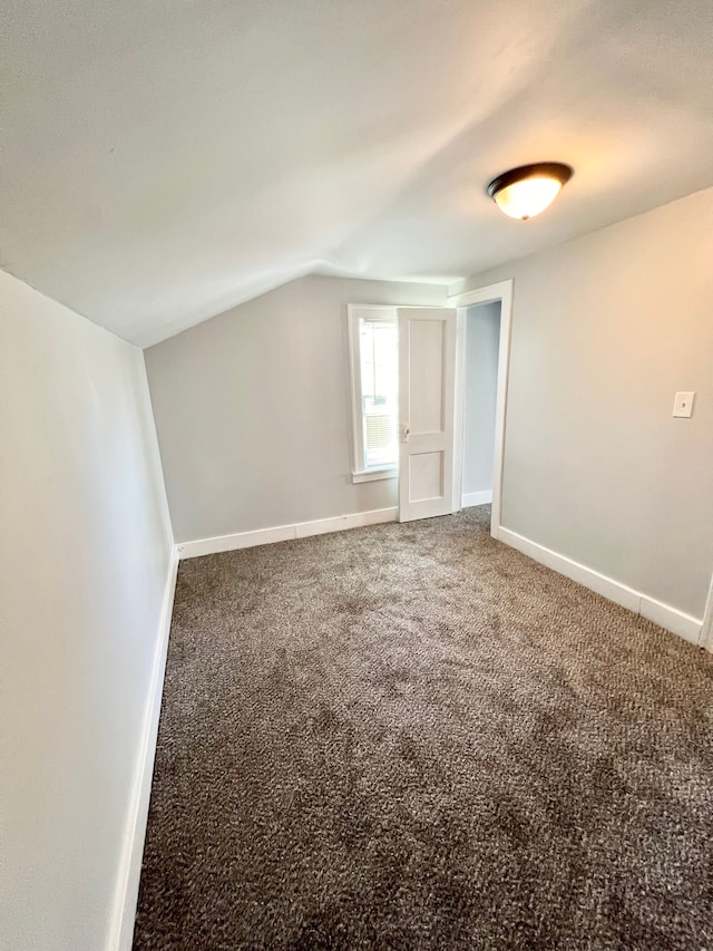 bonus room with carpet flooring and lofted ceiling