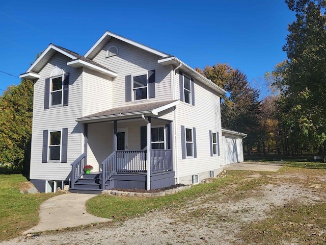 front of property with covered porch and a garage