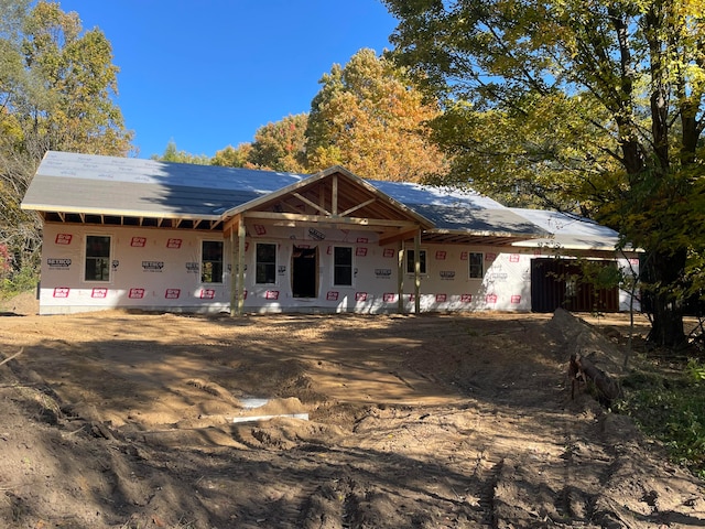 back of property featuring covered porch