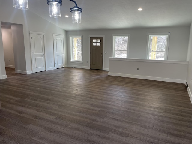 foyer featuring lofted ceiling, baseboards, and dark wood-style flooring