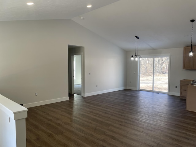 unfurnished living room with vaulted ceiling, dark wood-style floors, and baseboards