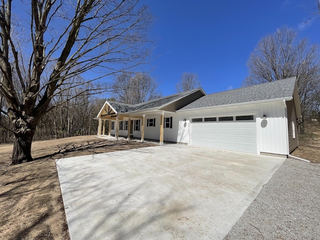 2412 W Garfield, New Era, MI 49446 - ranch-style house with roof with shingles, a garage, and concrete driveway