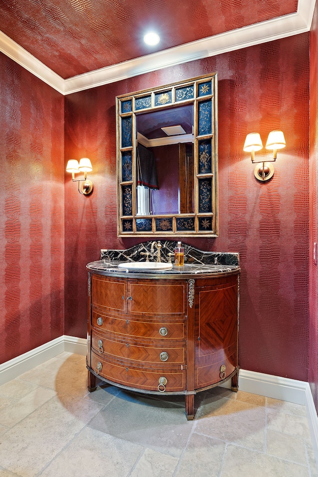 bathroom featuring ornamental molding, vanity, and baseboards