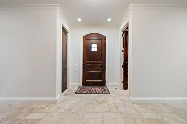 entryway featuring crown molding, baseboards, stone tile flooring, and recessed lighting