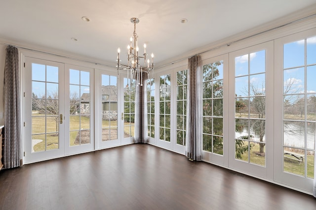 unfurnished sunroom featuring a water view, visible vents, and a notable chandelier