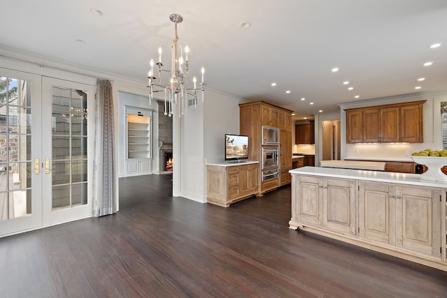 kitchen featuring crown molding, light countertops, and pendant lighting