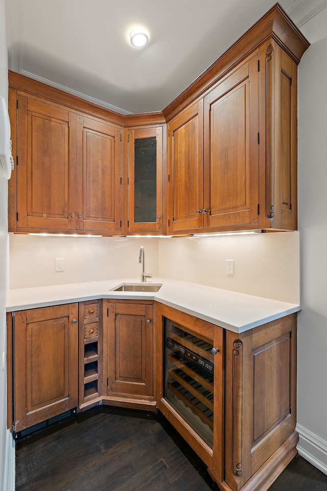 kitchen featuring brown cabinetry, light countertops, and a sink