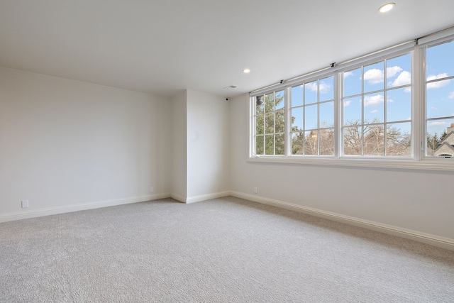 carpeted empty room with baseboards and recessed lighting