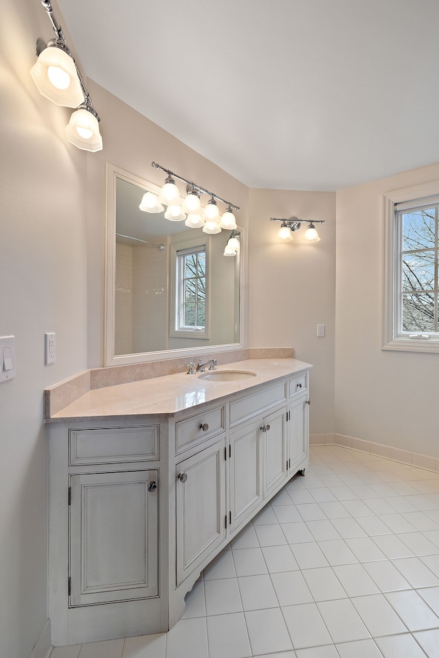 full bathroom featuring tile patterned floors, vanity, and baseboards