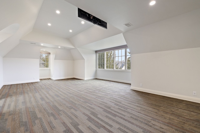 bonus room with a healthy amount of sunlight, baseboards, visible vents, and vaulted ceiling