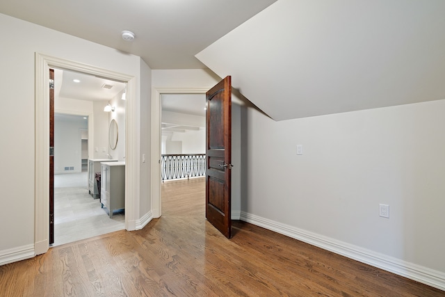 additional living space featuring visible vents, light wood-style flooring, and baseboards