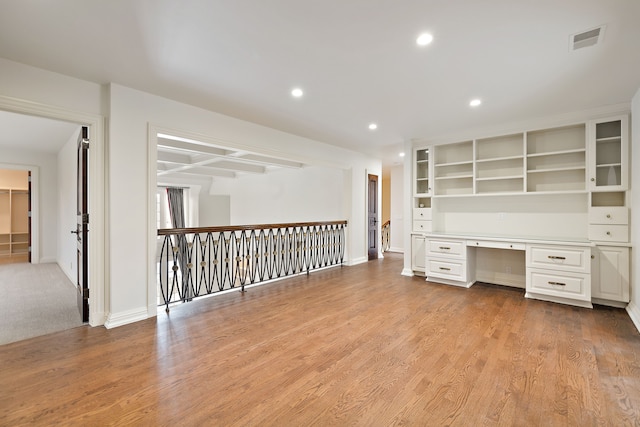 unfurnished office featuring visible vents, baseboards, built in study area, light wood-style flooring, and recessed lighting