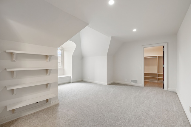 additional living space featuring lofted ceiling, recessed lighting, light carpet, visible vents, and baseboards