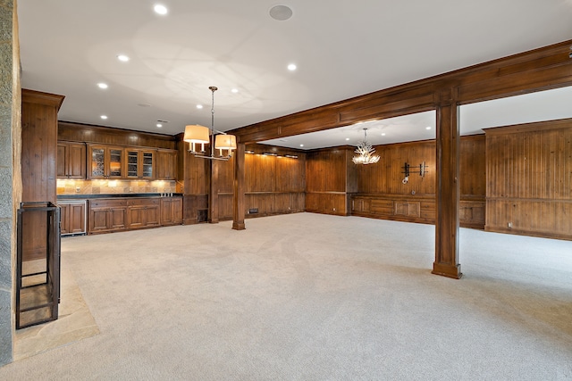 basement featuring recessed lighting, wooden walls, a notable chandelier, and light colored carpet