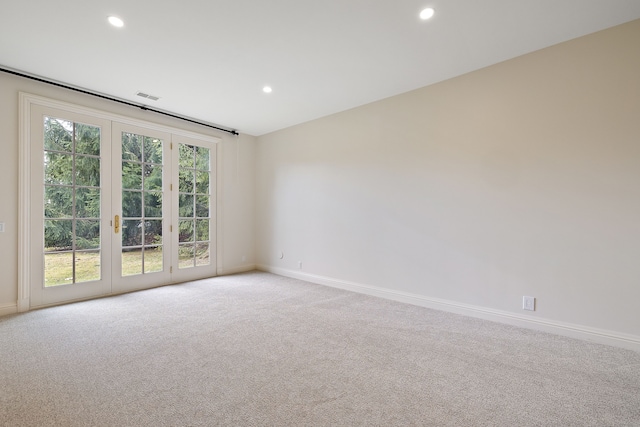 spare room featuring baseboards, visible vents, light colored carpet, french doors, and recessed lighting