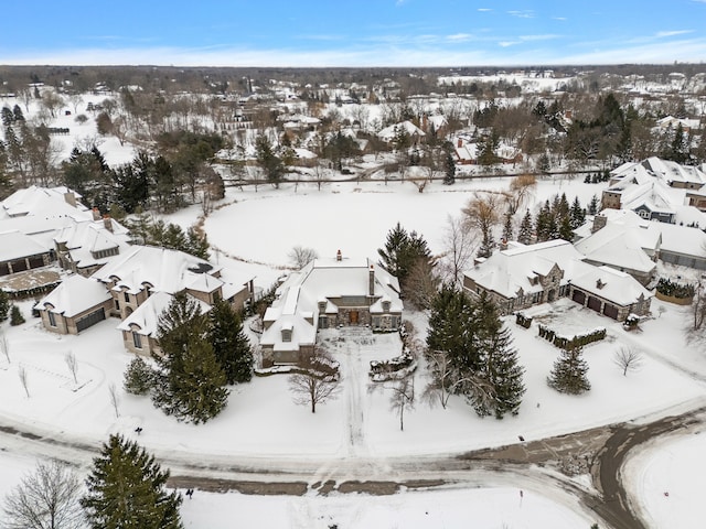 snowy aerial view with a residential view