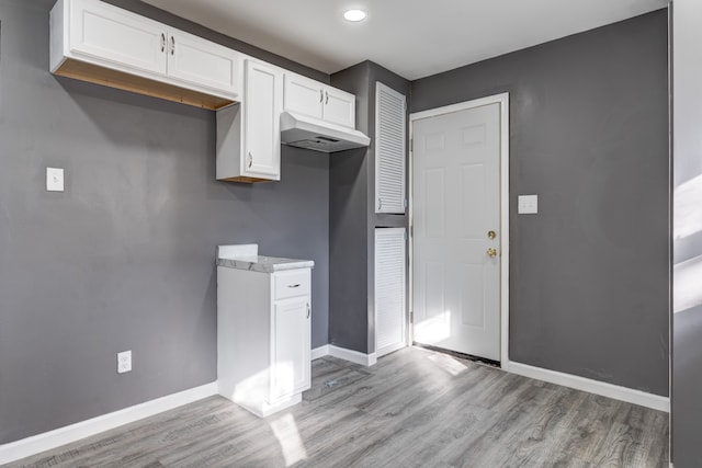 kitchen featuring white cabinets and light wood-type flooring