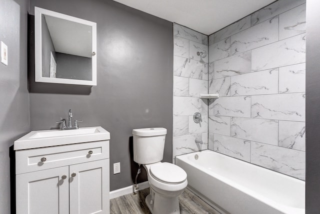 full bathroom with hardwood / wood-style floors, tiled shower / bath combo, toilet, and vanity