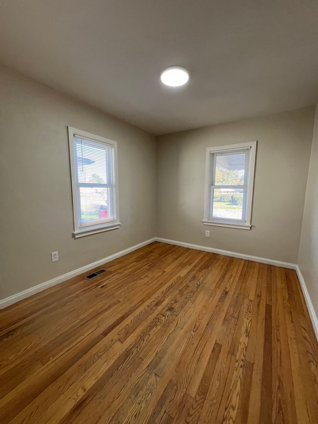 unfurnished room with light wood-type flooring