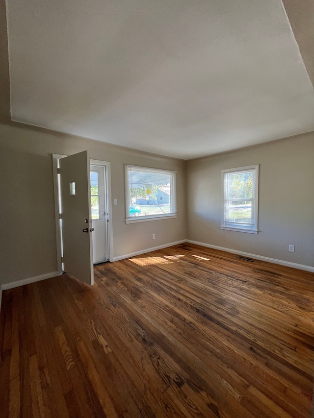 interior space with dark hardwood / wood-style floors and a wealth of natural light