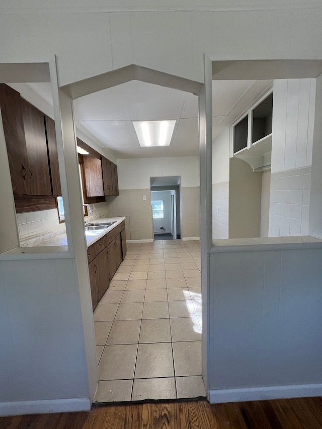 kitchen featuring backsplash, sink, and light wood-type flooring