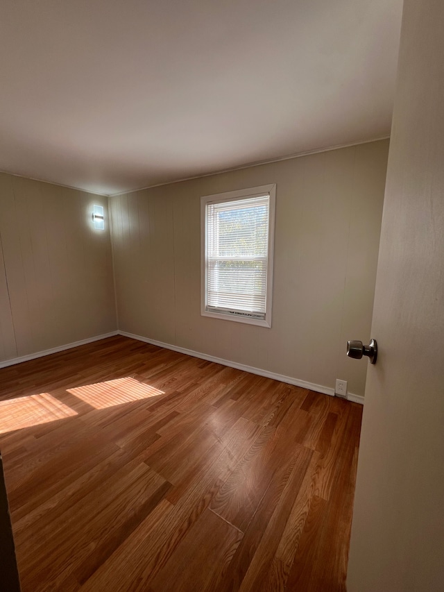 unfurnished room featuring hardwood / wood-style floors