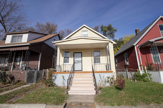 bungalow-style home with a front yard and a porch