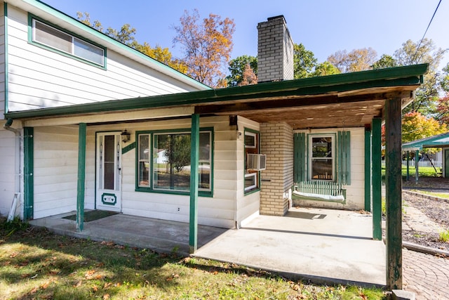 21048 Whitlock St, Farmington Hills, MI 48336 - entrance to property featuring covered porch, a chimney, and cooling unit
