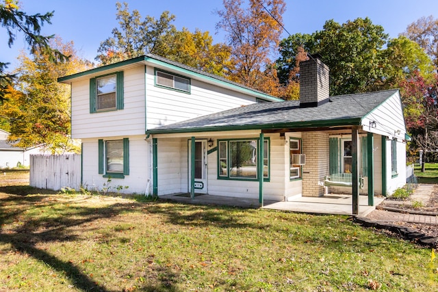 rear view of house with a lawn